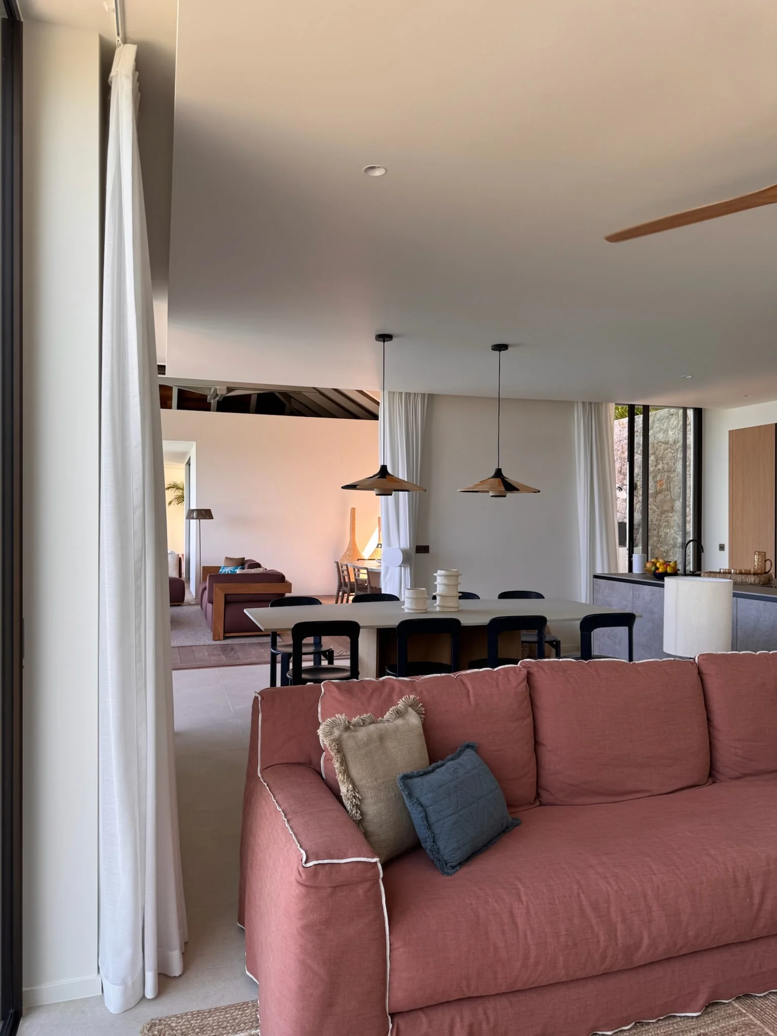 Pink sofa and open-plan dining area — Anse des Cayes