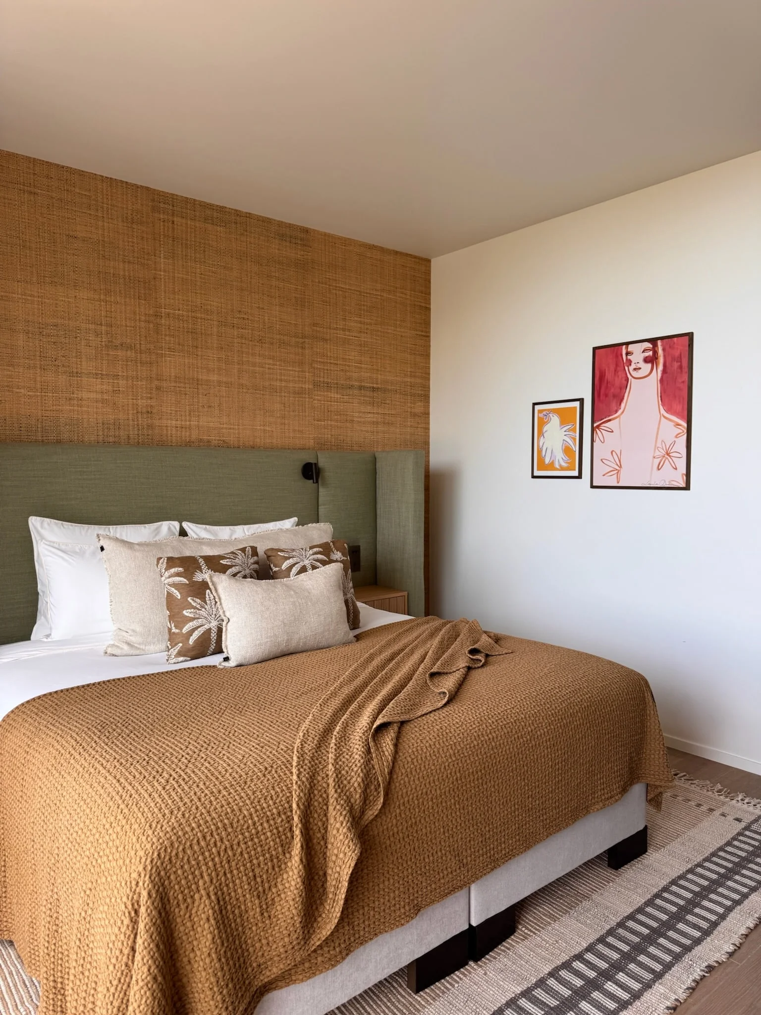 Bedroom with woven wall panel, green headboard and ochre throw — Anse des Cayes