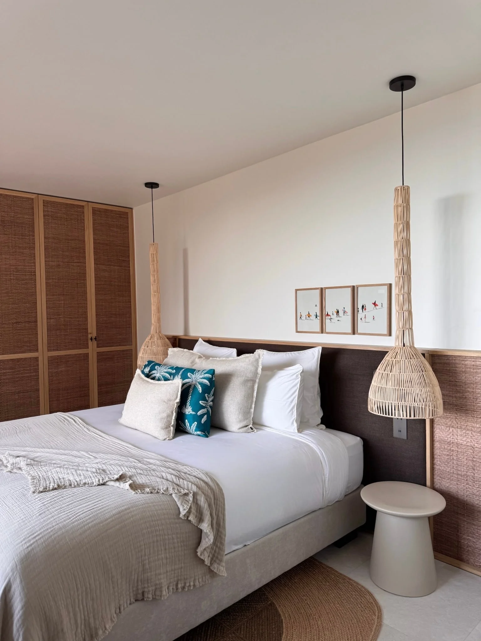 Bed with woven pendant lights and round bedside tables — Anse des Cayes