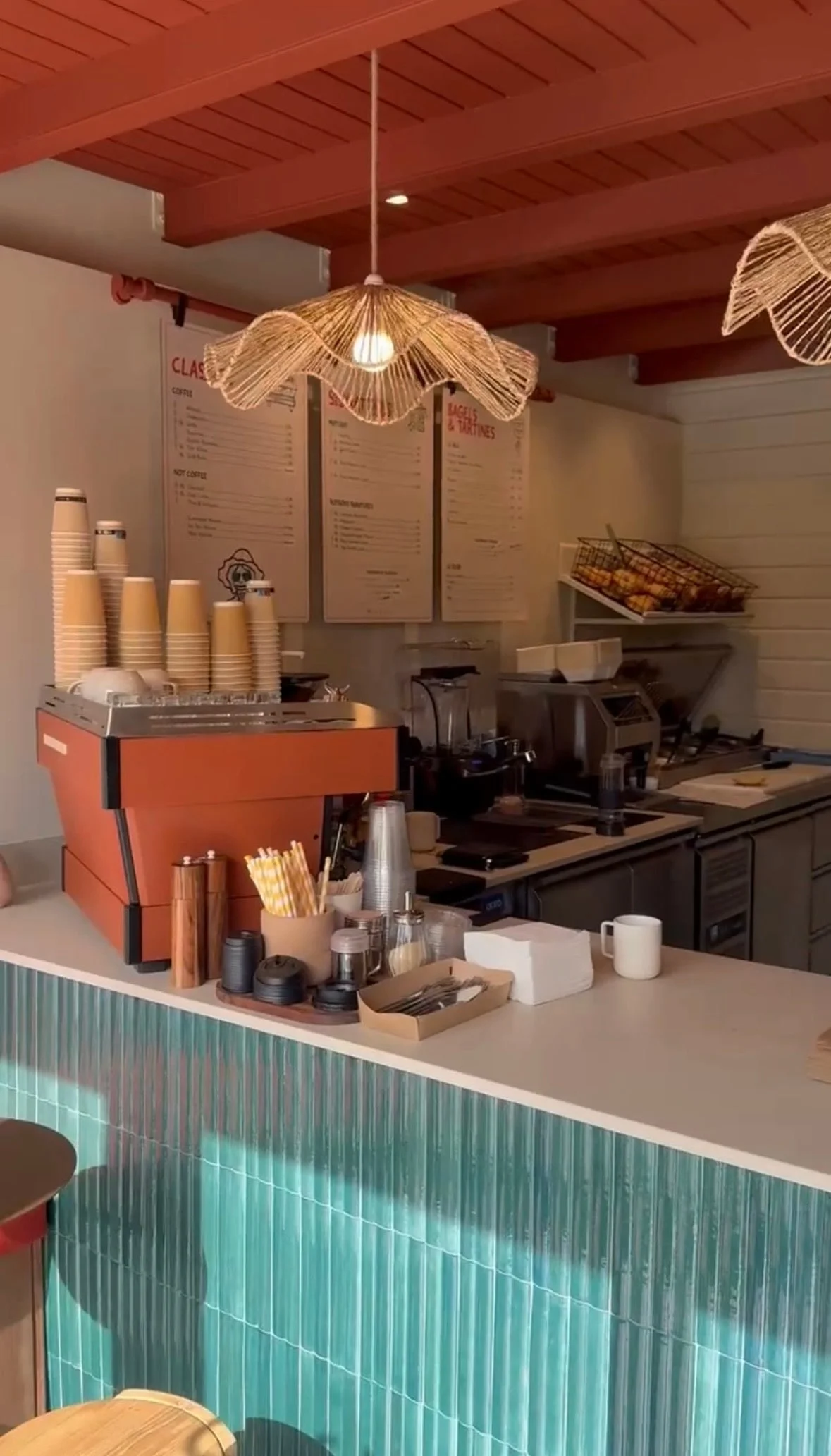 Espresso machine and pastries on the curved counter — Dado Café