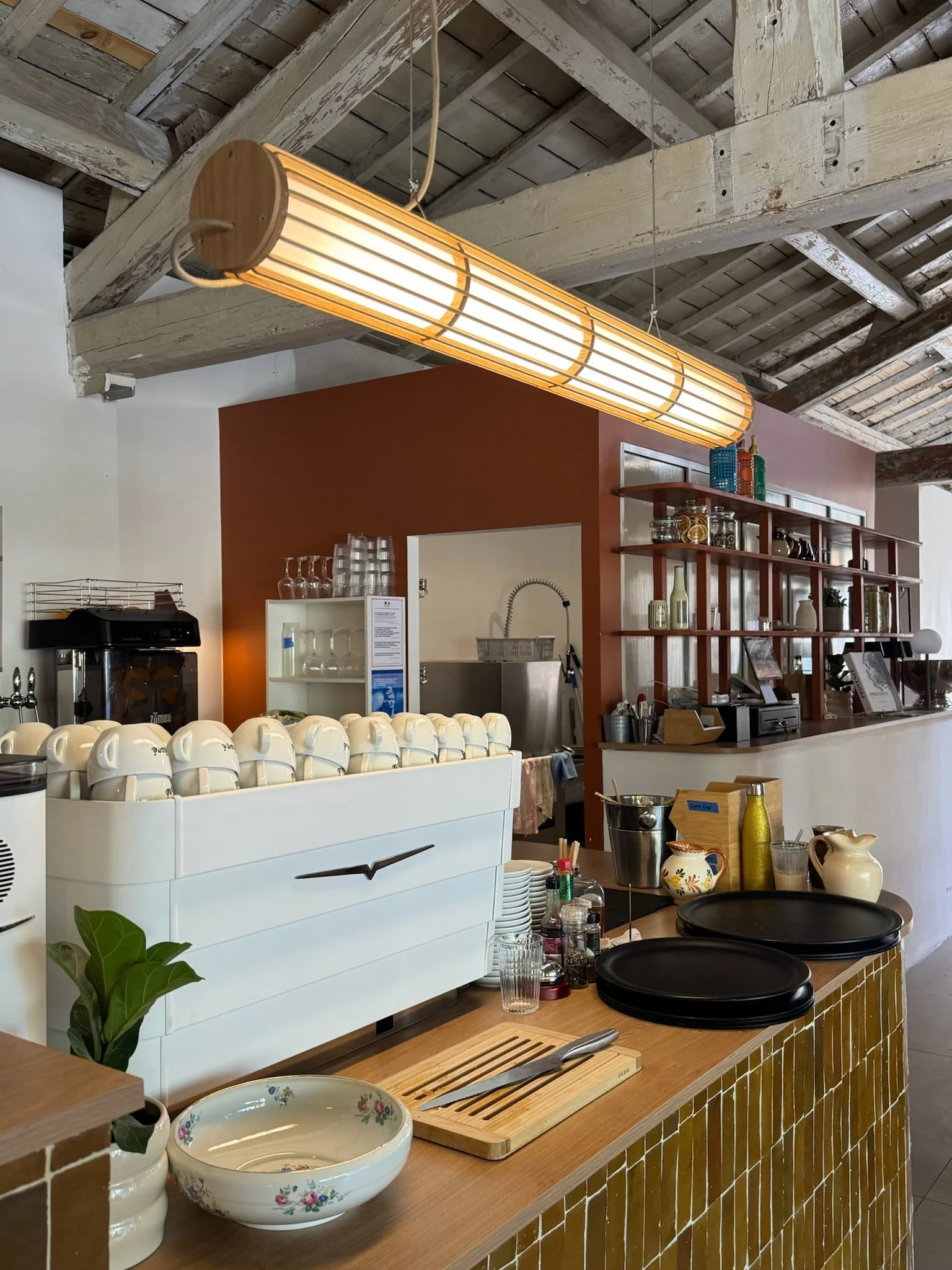 Coffee station and terracotta wall behind the counter — Honoré Brunch