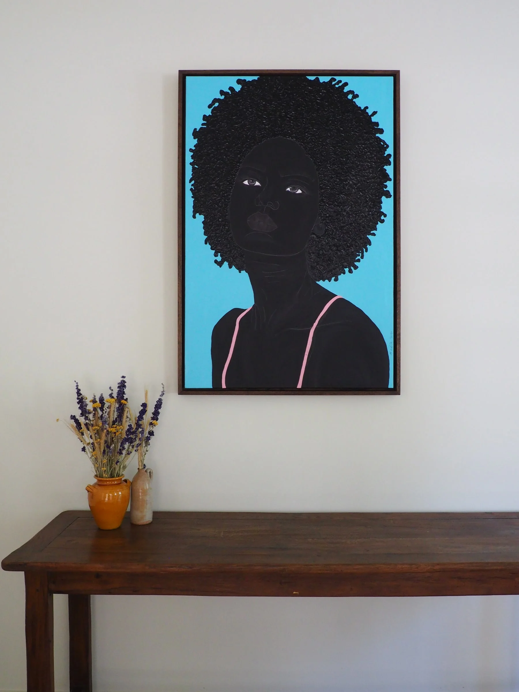 Portrait painting above a wooden console — Montjoie